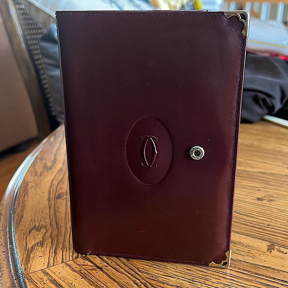 Vintage Cartier leatherwallet/passport holder.Very good condition. Brass. unisex